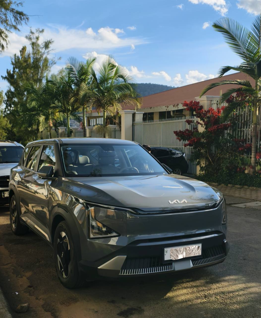 The client’s 2025 Kia EV5 Air parked outdoors, shown from the front and side
